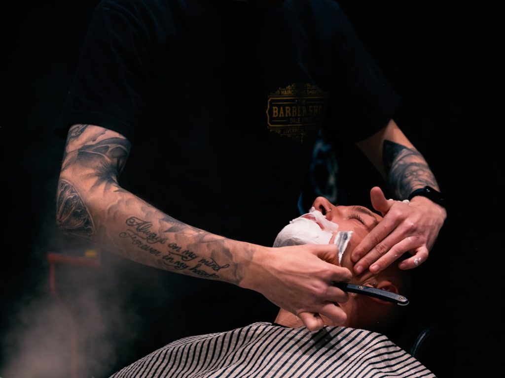 a-man-getting-his-hair-cut-by-a-barber-idbtduzqtxy
