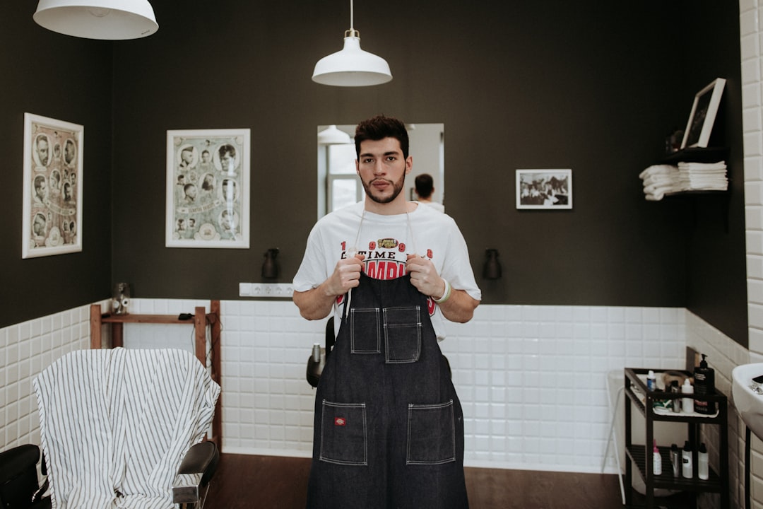 man-in-white-t-shirt-holding-jumpsuit-under-pendant-lamp-yyqdjtemqiu